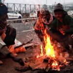 New Delhi: People keep themself warm by sitting around a bonfire on a cold day in the early morning in New Delhi on Friday, December 23, 2022. (Photo: Wasim Sarvar/IANS)