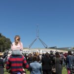 Photo taken on March 15, 2021 shows marches and protests in front of the Parliament House in Canberra, Australia. (Photo by Liu Changchang/Xinhua)