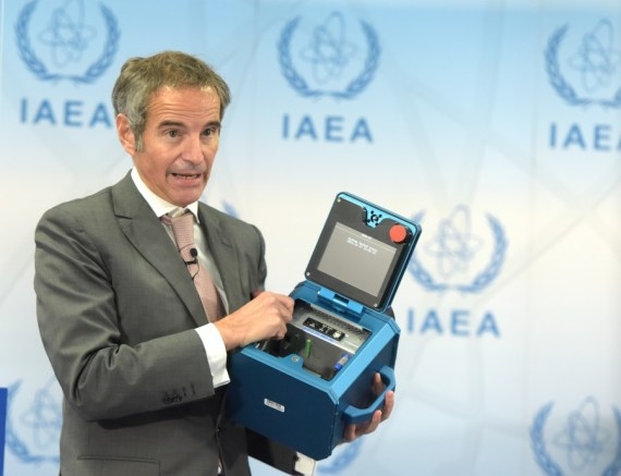 Rafael Mariano Grossi, Director General of the International Atomic Energy Agency (IAEA), displays a surveillance camera during a press conference in Vienna, Austria, Dec 17, 2021. (Xinhua/Guo Chen/IANS)
